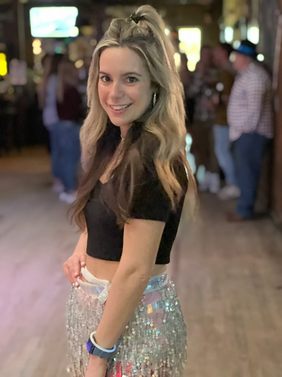 A guest in a sparkling outfit on the dance floor at Cadillac Ranch