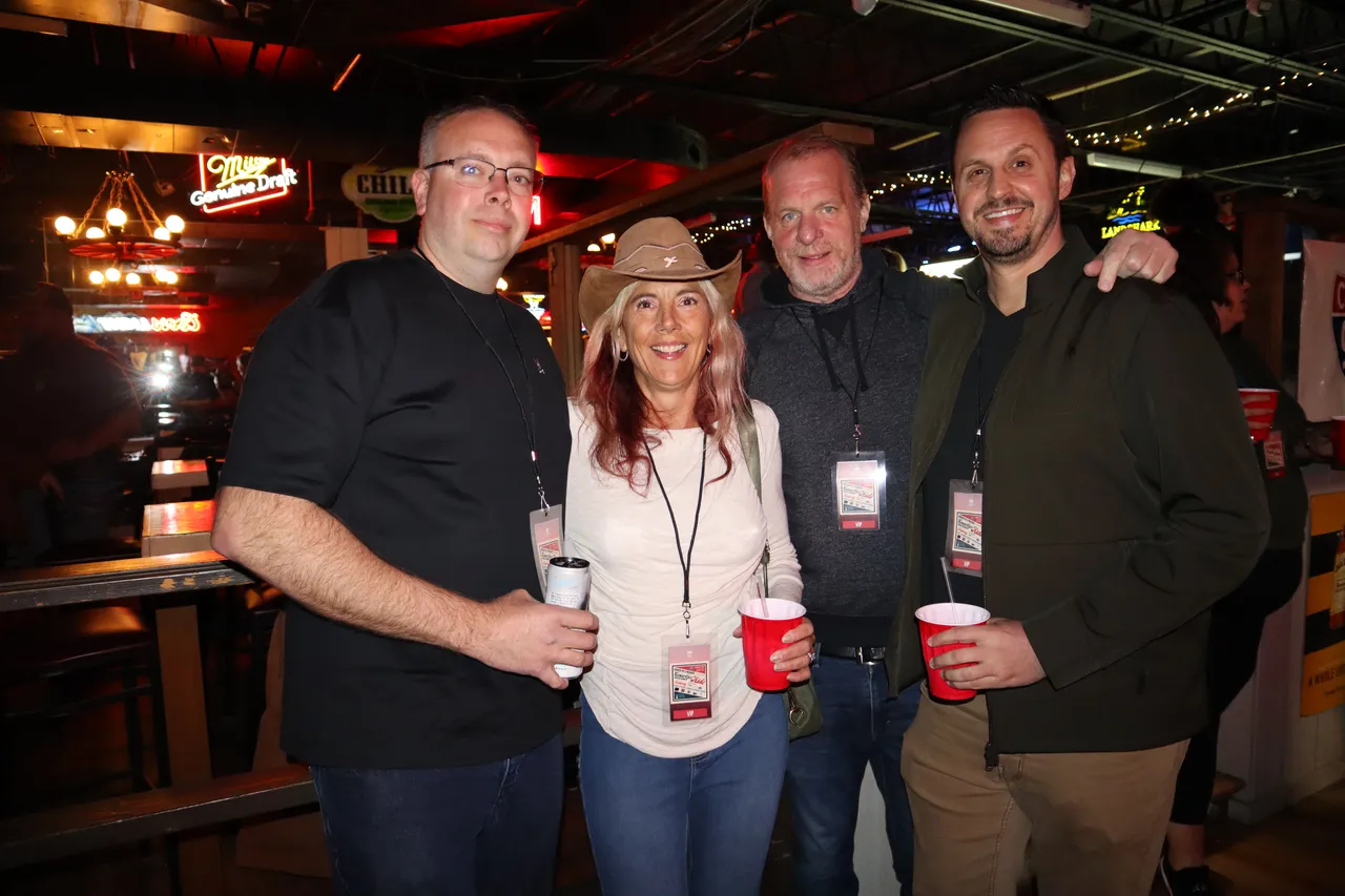 A group of friends raising drinks together at Cadillac Ranch