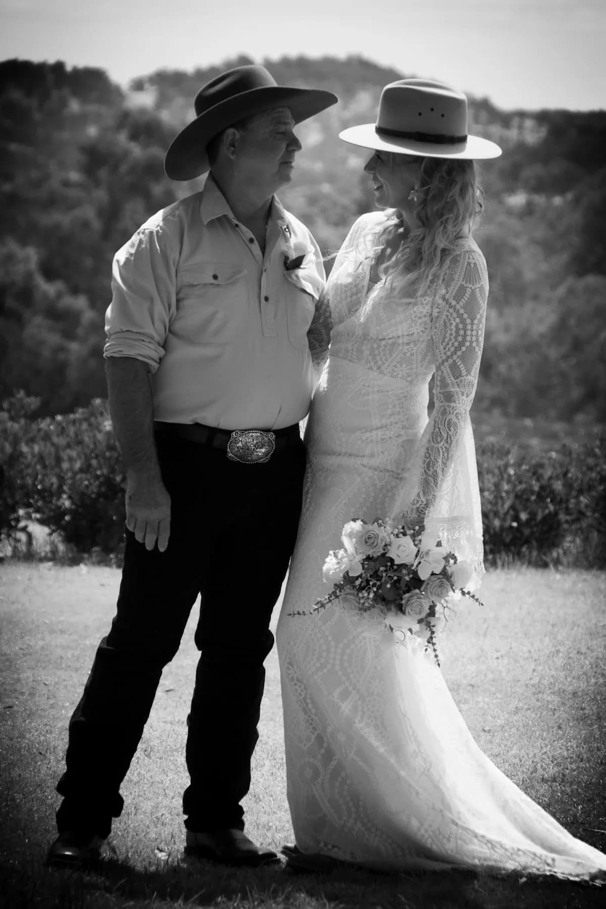 A country bride and groom in cowboy hats on their wedding day